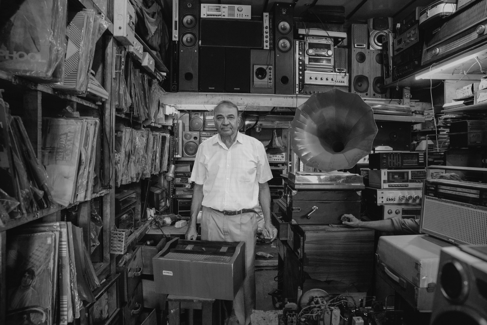 Collector in a shop of vintage music gear and radios